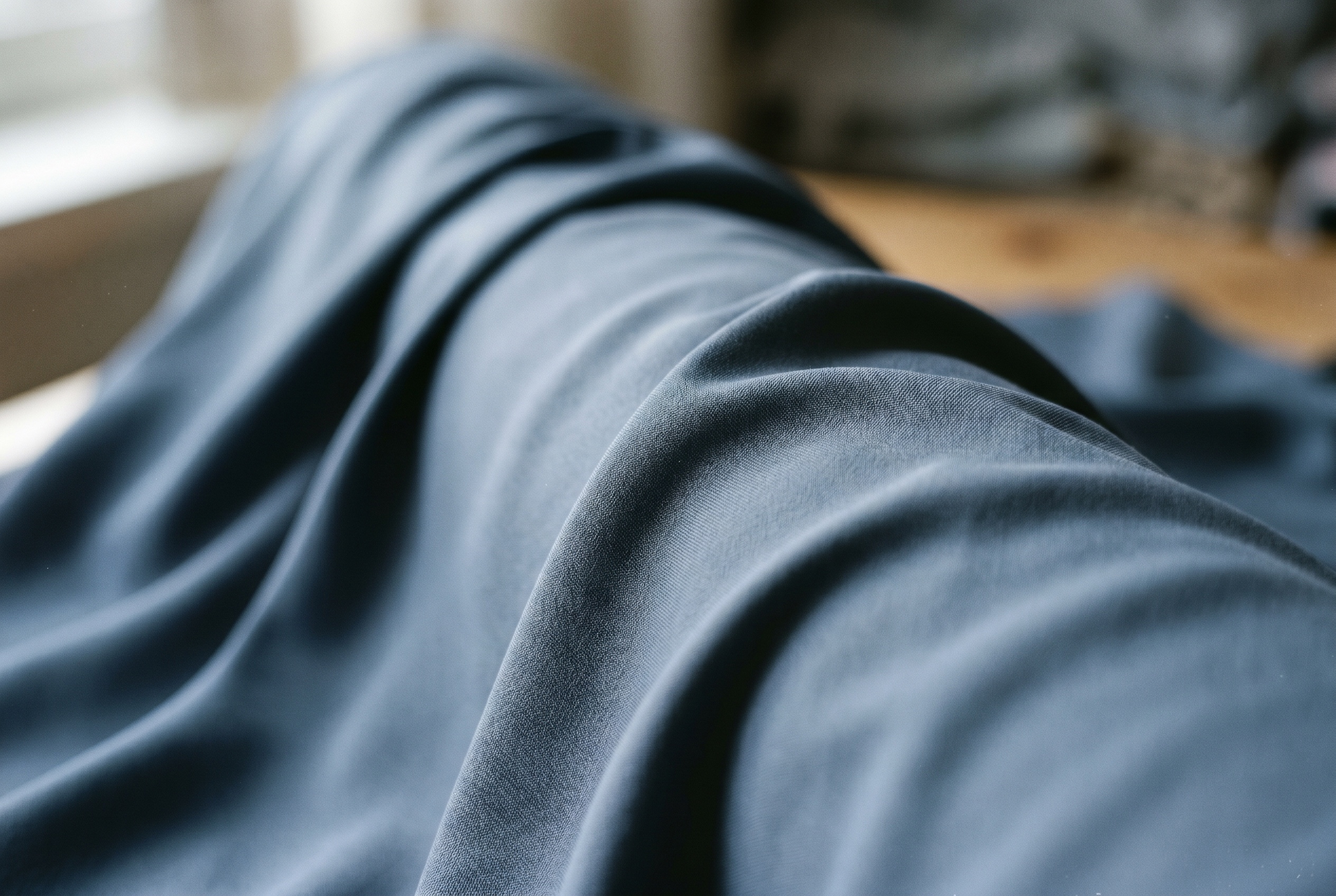 Macro of smooth slate-blue viscose and lyocell fabric draping