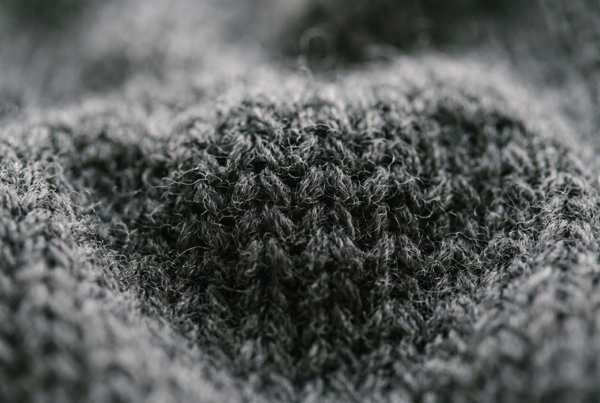 Macro of fine merino wool knit in charcoal